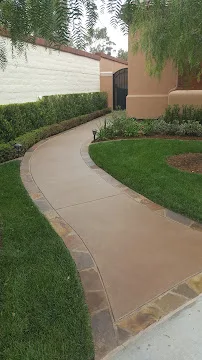 Curved concrete driveway entry after repair and sealing