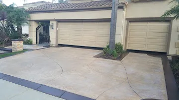 Sealed concrete driveway with an even restored finish