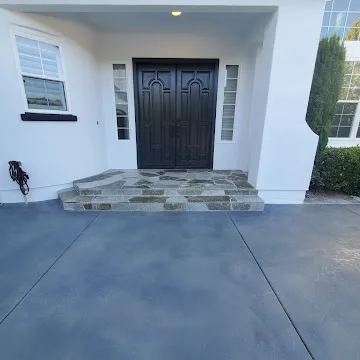 Front entry with dark stained concrete finish